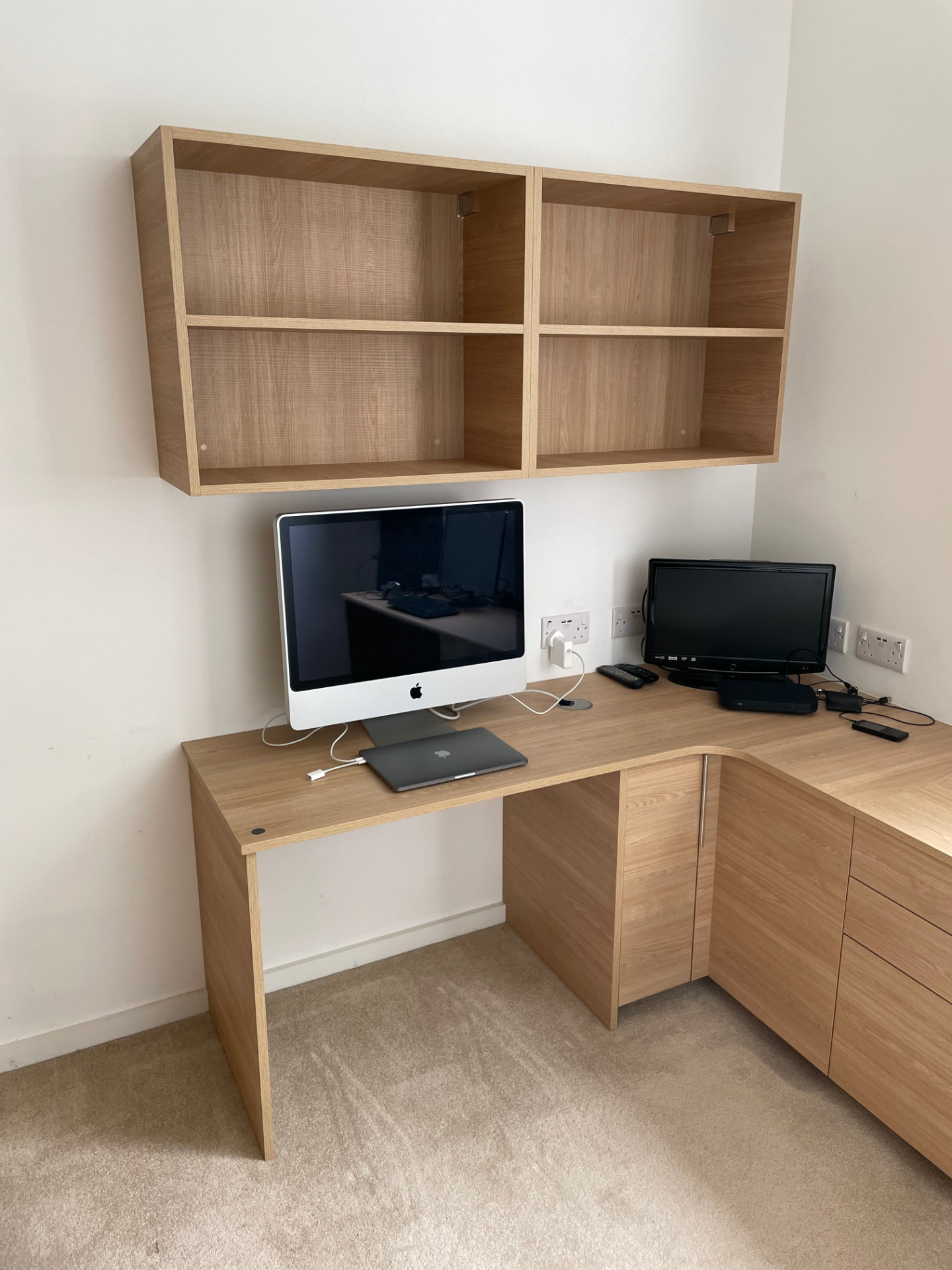 Oak corner home office desk with fitted drawers, cupboards and wall shelving